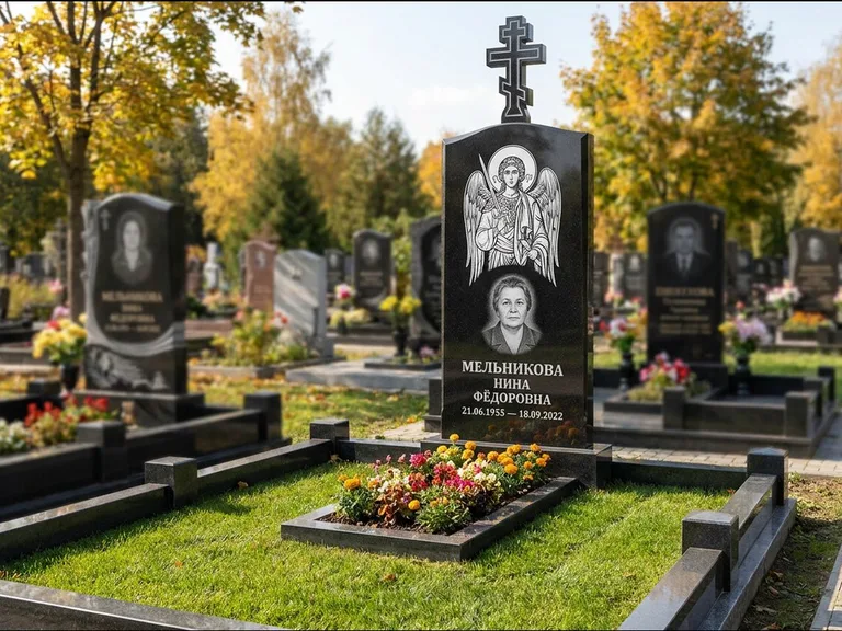 Памятник с гравировкой иконы: округлая стела-медальон с ликом — гравировка Богородицы «Семистрельная», луговые травы и полевые цветы за участком, работа «Гущин» в Краснодаре